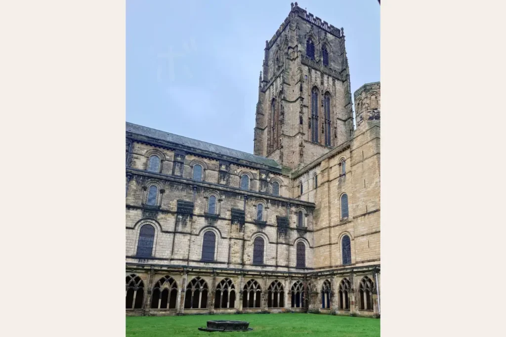 A quiet view of Durham Cathedral’s courtyard and cloister, looking up toward the tower