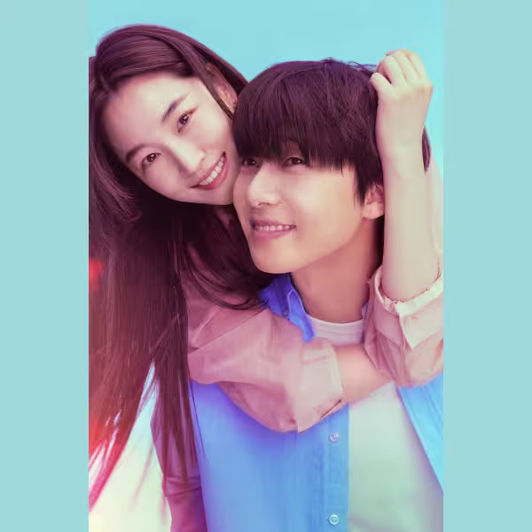 青い背景の前で、女性が男性の肩に腕を回しながら微笑んでいる姿が大きく写されたポスターイメージ。