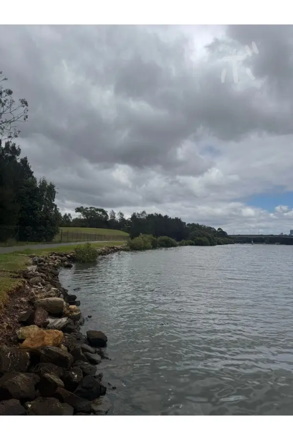 The view of the lake continues quietly under a sky of thick clouds.