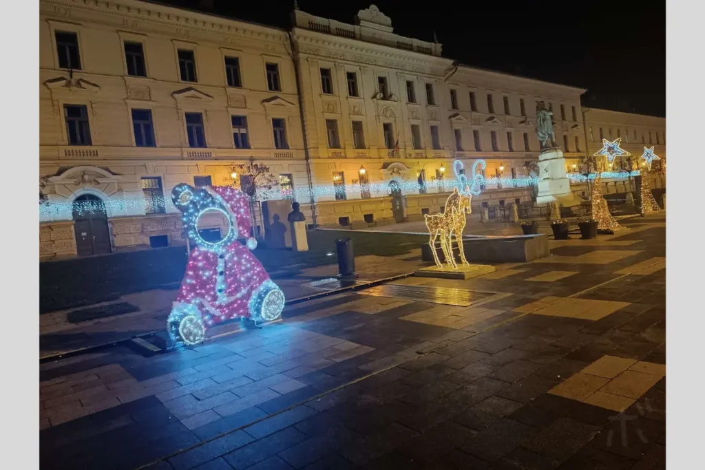 Illuminated bear and reindeer objects set up on a street on a winter night