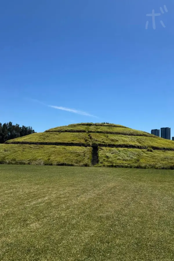 A view of a large grass-covered hill in Homebush, Sydney, Australia.