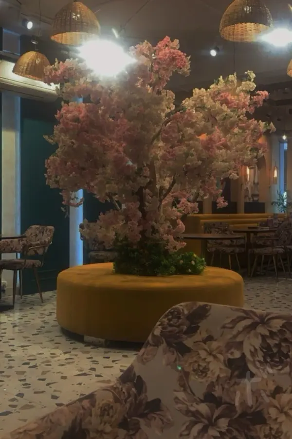 Inside a Japanese restaurant in India and a floral objet d'art in the center.