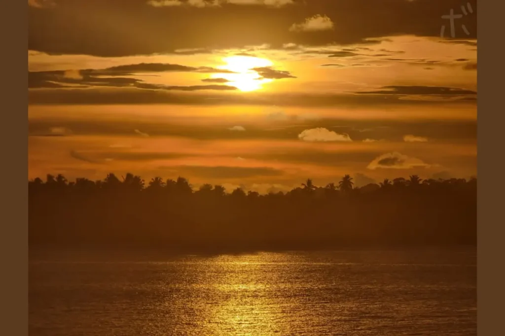 The sky and the sea, tinted with sunset, spread out in layers.