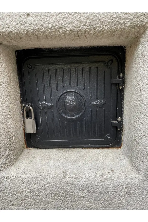 A small black door embedded in the wall of the Ghibli Museum