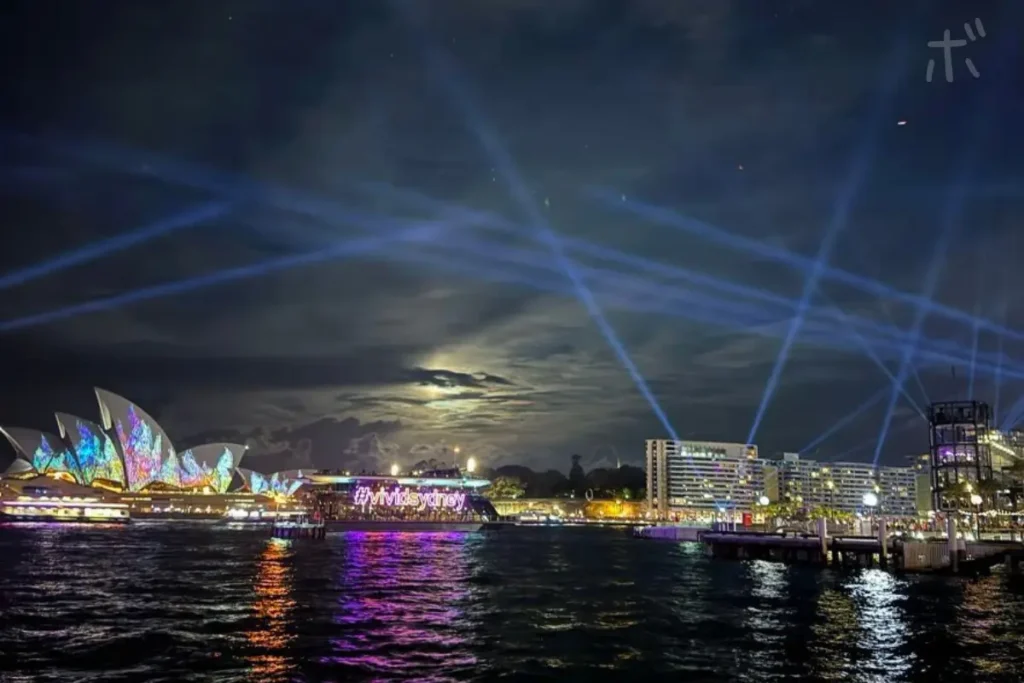 Illuminated Opera House and lights in the night sky