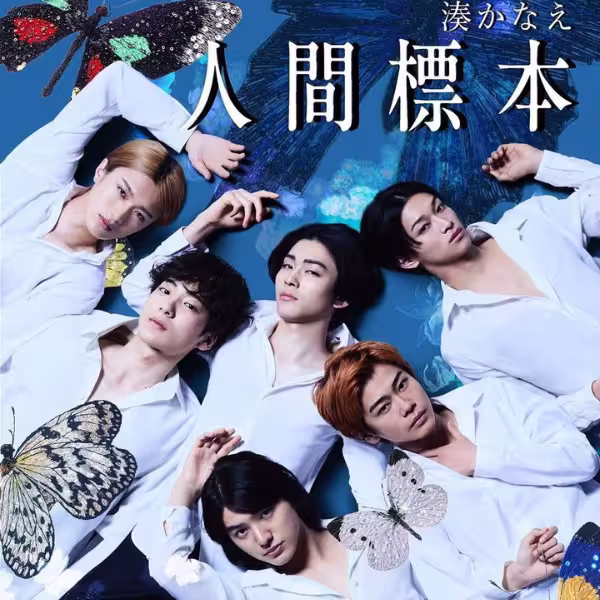 青い背景の上に複数の大きな蝶のイラストが舞い、白いシャツを着た複数の人物が横たわりながらカメラの方向を向いているビジュアル。